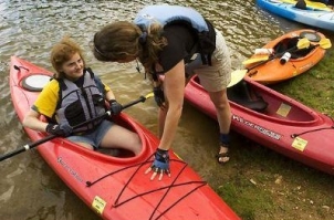Joanne Garlow of the Special Olympics kayaking team helps Ashley Thompson with her kayak last month