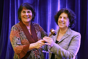 Leslie Cohen, JD (right) accepts the gavel from outgoing AUCD President Julie Fodor, PhD at the 2013 AUCD Conference.