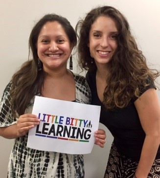 2 women holding a sign that says Little Bitty Learning