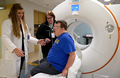 Washington University senior clinical research coordinator Brittany Nelson (front) helps study participant Adam Kloppenburg get a brain scan as part of a study on the intersection of Down syndrome and Alzheimer's disease. 
