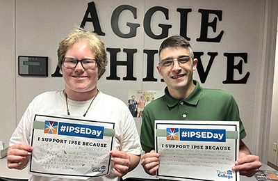 ulia and Sean holding up signes that read IPSEDAY24