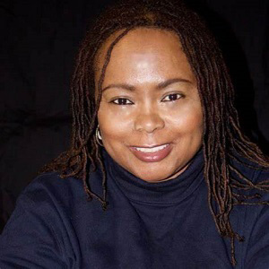 Image of Wendy Jones, a smiling black woman with braids wearing a black shirt.
