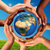 Image of different skin tone hands cradling a globe of the world