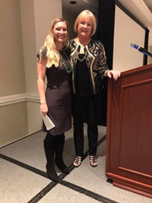  Recent SGISD PhD graduate Dr. Callie Brusegaard (left) and Dr. Laura Bozeman stand together at the podium at the Northeast Regional Association and Rehabilitation of the Blind and Visually Impaired regional conference.