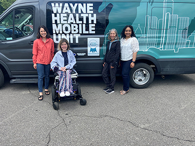 Image of staff in front of a the Wayne Health Mobil Unite Van