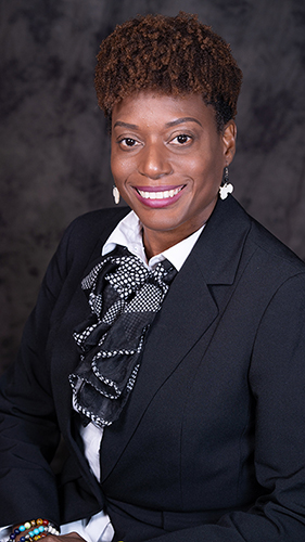 Image of a African American woman with short brown hair wearing a suit.