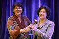 Leslie Cohen, JD (right) accepts the gavel from outgoing AUCD President Julie Fodor, PhD at the 2013 AUCD Conference.
