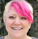 Image of a woman short hair with a pink streak. 