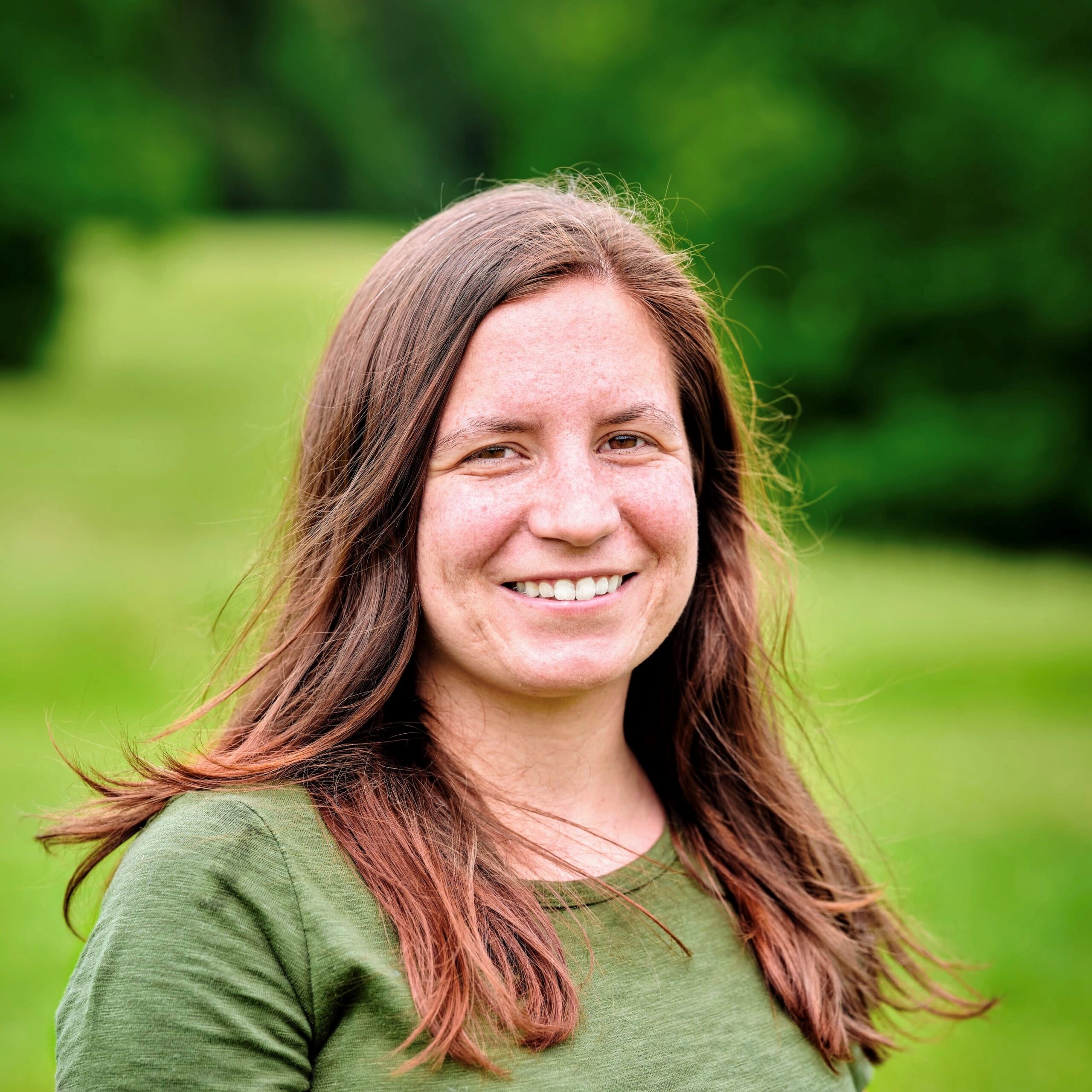 Smiling headshot of Micah Pepper, a white woman with long brown hair.