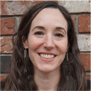 Smiling headshot of Micah Pepper, a white woman with long brown hair.