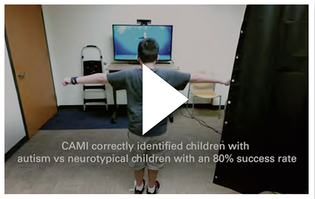 Eight adults stand and sit together outdoors in front of a large historic state capitol building with columns and ornate stonework. The group includes people with and without disabilities; one person sits in a wheelchair at the center. They are dressed in business and business-casual clothing, smiling and posing on a sunny day with the capitol grounds visible behind them