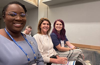 Attendees smile during the opening session of an AUCD Conference.