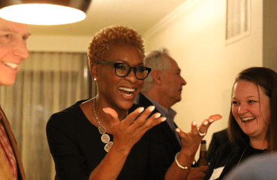 Supporter Claudia Gordon a black woman with short hair signing to a group of people.