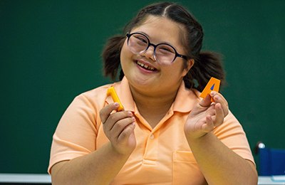 Young woman wearing glasses smiling.