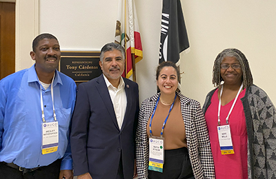 AUCD network members are standing with the congressman in front of his office.