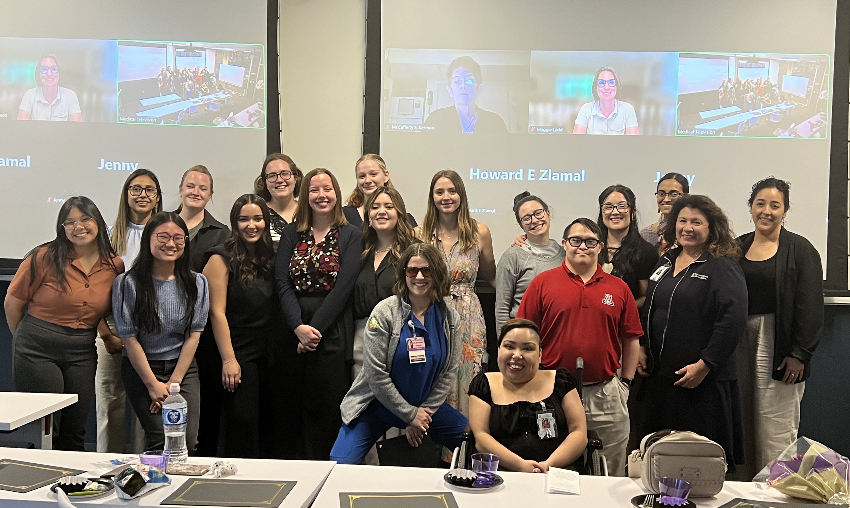 er ArizonaLEND faculty, standing together in conference room with online class projectd on the wall.