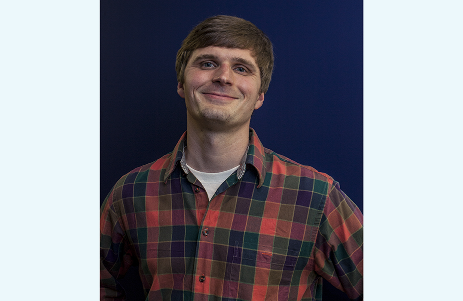 Bryan Boyce, a white man with brown hair wearing a flannel shirt. 