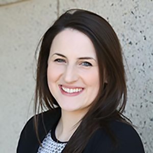 Image of Jackie Czyzia, a smiling white woman with long brown hair, she is wearing a jacket and blouse.