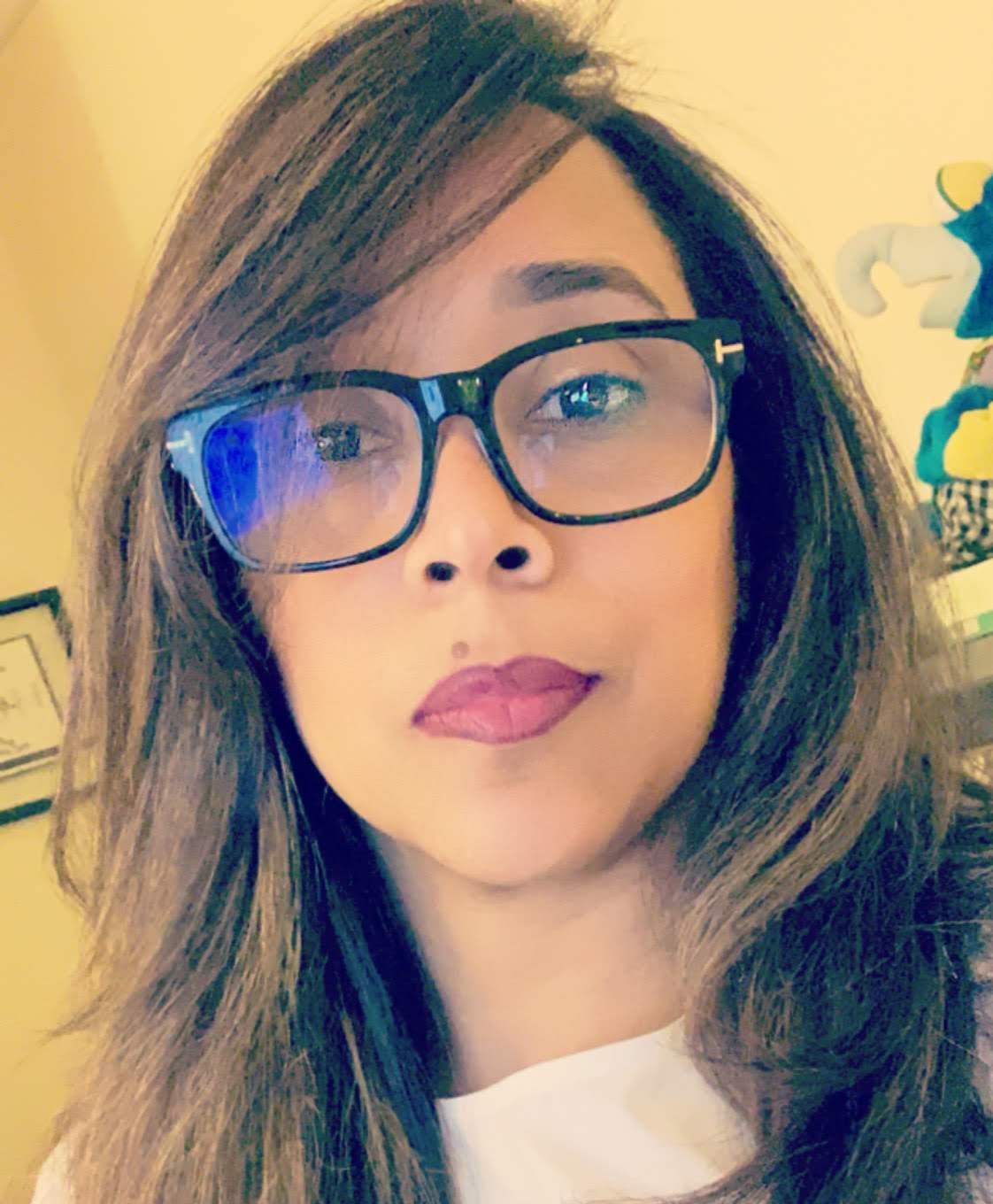 Image of Rose Rodriguez, woman with brown hair wearing pink shirt.
