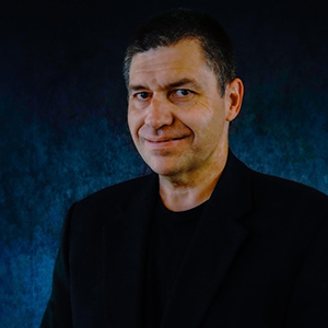 Michael Thornton, a white man with a buzz cut wearing a black shrit and jacket.