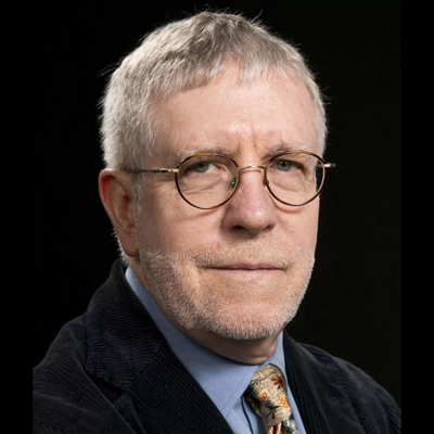 Image of John O'Neil, a white male with grey hair with beard stubble, he is wearing a suit with a tie.