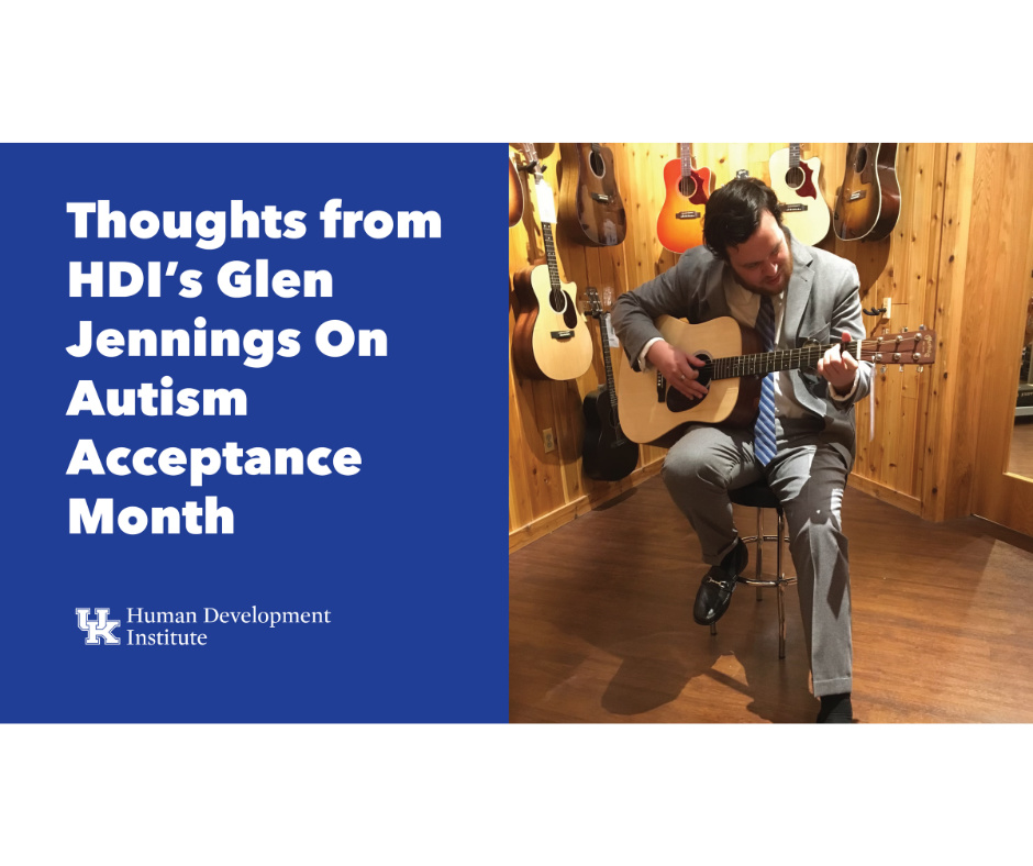 Image featuring Glen Jennings from the Human Development Institute, expressing his thoughts for Autism Acceptance Month. Glen, dressed in a gray suit and blue striped tie, is seated on a stool playing an acoustic guitar in a room surrounded by various guitars hanging on wooden walls. The left side of the image has a bold blue background with white text stating 'Thoughts from HDI’s Glen Jennings On Autism Acceptance Month,' followed by the logo of the Human Development Institute at the bottom.